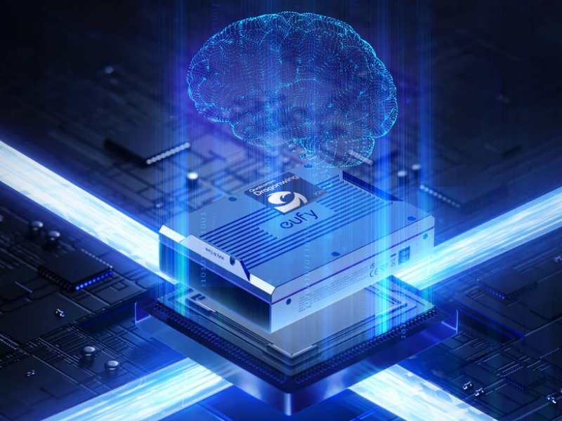 Een blauw-zilverkleurige Eufy AI Core chip met logo en de tekst "Qualcomm Dragonwing 100" op een donkere printplaat. Helderblauwe lichtstralen en een gloeiend blauw draadframe van hersenen omringen de chip. Witte tekst bovenaan luidt "Coming Soon".