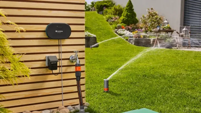 Een Gardena smart besproeiingssysteem aan een houten wand regelt automatisch het gazon sproeien hittegolf voor een vitale en groene achtertuin.