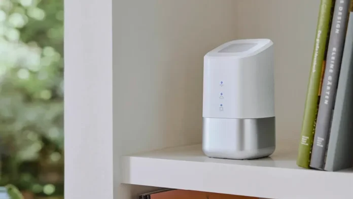 Witte homeatic smart home hub op een plank naast boeken voor een slimme woning.